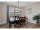 Charming dining room with a wooden table, chandelier, and natural light from the large windows at 12515 Horseshoe Bend Dr, Lithia, FL 33547