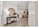 Stylish foyer with wood-look tile, arched mirror, and view to the living spaces at 12515 Horseshoe Bend Dr, Lithia, FL 33547
