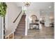 Elegant foyer with wood-look tile, staircase, and stylish decor at 12515 Horseshoe Bend Dr, Lithia, FL 33547