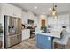 Well-equipped kitchen with stainless steel appliances, a center island, and bright white cabinetry at 12515 Horseshoe Bend Dr, Lithia, FL 33547