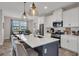 Kitchen with a central island, bar stool seating, stainless steel appliances, and white cabinets at 12515 Horseshoe Bend Dr, Lithia, FL 33547