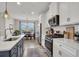 Kitchen showcasing stainless appliances, granite countertops, and seamless flow to dining area at 12515 Horseshoe Bend Dr, Lithia, FL 33547