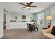 Large living room with custom built-ins, a ceiling fan, and a table with four chairs for entertaining at 12515 Horseshoe Bend Dr, Lithia, FL 33547