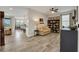 Open-concept living room with built-in bookcase and adjacent dining area at 12515 Horseshoe Bend Dr, Lithia, FL 33547