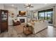 Bright living room with a fireplace, TV, and access to the outdoor patio at 12515 Horseshoe Bend Dr, Lithia, FL 33547