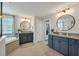 Dual sink bathroom with granite countertops, framed mirrors and a soaking tub near a window at 12515 Horseshoe Bend Dr, Lithia, FL 33547