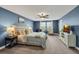 Inviting main bedroom with neutral colors, large windows, and a comfortable sitting area at 12515 Horseshoe Bend Dr, Lithia, FL 33547