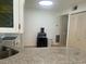 Well-lit kitchen showcasing granite countertops and white appliances at 1655 S Highland Ave # B110, Clearwater, FL 33756