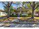 Charming craftsman style home featuring a covered porch, lush landscaping, and a welcoming entrance at 306 S Albany Ave, Tampa, FL 33606