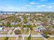 Wide aerial view of neighborhood with a house, trees, and buildings in the background at 4727 W Wyoming Ave, Tampa, FL 33616