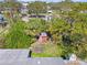 Aerial view of the lush backyard featuring a small red shed surrounded by mature trees and well-maintained lawn at 4727 W Wyoming Ave, Tampa, FL 33616