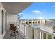 Inviting balcony with a table and chairs, offering picturesque views of the waterfront and bridge at 500 Treasure Island Cswy # 308, Treasure Island, FL 33706