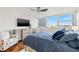 Well-lit bedroom offers a ceiling fan, a modern dresser, and peaceful water views at 500 Treasure Island Cswy # 308, Treasure Island, FL 33706