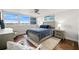 This inviting bedroom showcases hardwood floors, a ceiling fan, and peaceful water views at 500 Treasure Island Cswy # 308, Treasure Island, FL 33706
