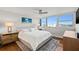 Bright bedroom boasts large windows, hardwood floors, ceiling fan and serene decor at 500 Treasure Island Cswy # 308, Treasure Island, FL 33706
