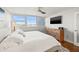 This main bedroom has hardwood floors, a ceiling fan, a TV, and views at 500 Treasure Island Cswy # 308, Treasure Island, FL 33706