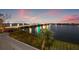 Scenic night view of bridge and water from a balcony with lush green landscaping at 500 Treasure Island Cswy # 308, Treasure Island, FL 33706