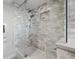 Glass shower features marble tile and dual shower heads at 500 Treasure Island Cswy # 308, Treasure Island, FL 33706