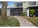 Charming backyard with screened patio, lush greenery, and a paved walkway, a tranquil outdoor space at 5100 Burchette Rd # 306, Tampa, FL 33647
