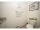 Well-lit bathroom with a toilet, towel rack, and decorative wall art at 5100 Burchette Rd # 306, Tampa, FL 33647