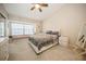 Bright bedroom featuring neutral walls, carpet floor, ceiling fan, and a large window seat at 5100 Burchette Rd # 306, Tampa, FL 33647