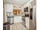 Bright kitchen with stainless steel appliances, white cabinets, and granite countertops at 5100 Burchette Rd # 306, Tampa, FL 33647