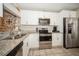 Bright kitchen with stainless steel appliances, white cabinets, and granite countertops at 5100 Burchette Rd # 306, Tampa, FL 33647