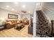 Bright and inviting living area with a comfortable sofa, open floor plan, and seamless transition to the stairs at 5100 Burchette Rd # 306, Tampa, FL 33647