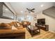 Comfortable living room with plush sofa, ceiling fan, and entertainment center, ideal for relaxation at 5100 Burchette Rd # 306, Tampa, FL 33647