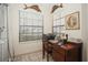 Cozy office space with a desk, artwork, and natural light from a window at 5100 Burchette Rd # 306, Tampa, FL 33647