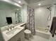 Bright bathroom featuring a bath with shower, white marble tiles, and modern vanity with sink at 6315 Shoreline Dr # 3204, Seminole, FL 33708