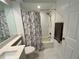 Bathroom with tiled shower/tub, white vanity and toilet, accented by gray tile flooring at 6315 Shoreline Dr # 3204, Seminole, FL 33708