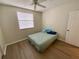 Comfortable bedroom features wood-look flooring, ceiling fan, and natural light at 6315 Shoreline Dr # 3204, Seminole, FL 33708
