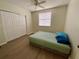 Bright bedroom features wood-look flooring and closet at 6315 Shoreline Dr # 3204, Seminole, FL 33708