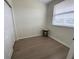 Bedroom featuring wood-look flooring, a window with blinds, and a closet with a stool at 6315 Shoreline Dr # 3204, Seminole, FL 33708
