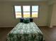 Bedroom with a patterned bedspread and pillows set in front of a window at 6315 Shoreline Dr # 3204, Seminole, FL 33708