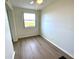 Bright bedroom featuring wood-look flooring, a ceiling fan, and a window with a pleasant outside view at 6315 Shoreline Dr # 3204, Seminole, FL 33708