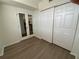 Bedroom featuring sliding closet doors, wood-look floors and a mirrored french door at 6315 Shoreline Dr # 3204, Seminole, FL 33708