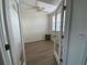 Bright bedroom showcasing wood-look flooring, ample natural light, and a comfortable stool at 6315 Shoreline Dr # 3204, Seminole, FL 33708