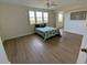 A bright bedroom featuring a large window, ceiling fan, and wood-look floors at 6315 Shoreline Dr # 3204, Seminole, FL 33708