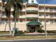 Beautiful condominium exterior with palm trees and manicured landscaping offers a welcoming entrance at 6315 Shoreline Dr # 3204, Seminole, FL 33708