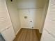 Walk-in closet with wood-look floors and built-in shelving at 6315 Shoreline Dr # 3204, Seminole, FL 33708