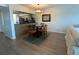 Dining area with a table, hardwood floors, and an adjacent kitchen with stainless steel appliances at 6315 Shoreline Dr # 3204, Seminole, FL 33708