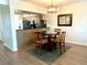 Dining area with a table, hardwood floors, and an adjacent kitchen with stainless steel appliances at 6315 Shoreline Dr # 3204, Seminole, FL 33708
