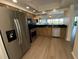 Spacious kitchen features granite countertops, stainless steel appliances, modern lighting and updated flooring at 6315 Shoreline Dr # 3204, Seminole, FL 33708