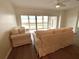 Bright living room featuring neutral furniture, hardwood floors, and a sliding glass door to the balcony at 6315 Shoreline Dr # 3204, Seminole, FL 33708