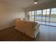 Bright living room features hardwood floors, neutral furniture, and a sliding glass door to the balcony at 6315 Shoreline Dr # 3204, Seminole, FL 33708