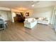 Spacious living room with wood-style flooring, neutral paint, and open layout to the kitchen and dining area at 6315 Shoreline Dr # 3204, Seminole, FL 33708