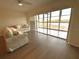 Bright living room features tile floors, neutral furniture, and access to an enclosed balcony at 6315 Shoreline Dr # 3204, Seminole, FL 33708