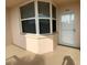 Enclosed porch featuring neutral paint color, corner window, and front door with storm door at 6315 Shoreline Dr # 3204, Seminole, FL 33708